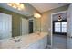 Bathroom featuring dual sinks, a wide mirror, a toilet and tan painted walls at 1703 Rifle Sw Rdg, Marietta, GA 30064