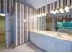 Bathroom with dual sinks, a wide mirror, and a shower with glass doors at 1703 Rifle Sw Rdg, Marietta, GA 30064