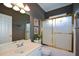 Bathroom featuring vanity, large mirror, decorative gold trimmed shower doors and gray walls at 1703 Rifle Sw Rdg, Marietta, GA 30064