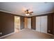 A large bedroom featuring plush carpeting, a ceiling fan, and access to an ensuite bath at 1703 Rifle Sw Rdg, Marietta, GA 30064
