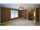 This cozy bedroom features neutral carpeting, a ceiling fan, and a sun-filled window at 1703 Rifle Sw Rdg, Marietta, GA 30064