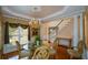 Elegant dining room featuring hardwood floors, a chandelier, and large windows at 1703 Rifle Sw Rdg, Marietta, GA 30064