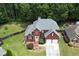 Aerial view of a well-manicured lawn and a two-car garage, showcasing the brick facade at 1703 Rifle Sw Rdg, Marietta, GA 30064