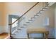 Bright foyer features hardwood floors, wainscoting and a staircase with white risers and stained handrail at 1703 Rifle Sw Rdg, Marietta, GA 30064