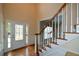 Inviting foyer featuring hardwood floors, elegant front door, and staircase at 1703 Rifle Sw Rdg, Marietta, GA 30064