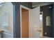 Hallway featuring white trim, neutral walls, an arched alcove, and access to the bathroom at 1703 Rifle Sw Rdg, Marietta, GA 30064