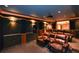A luxurious home theater featuring plush seating, custom lighting, and a convenient wet bar for the ultimate entertainment experience at 1703 Rifle Sw Rdg, Marietta, GA 30064