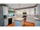 Kitchen featuring an island, white cabinets, and stainless steel appliances at 1703 Rifle Sw Rdg, Marietta, GA 30064