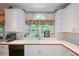 Kitchen with a white sink, stainless appliances, and a large window for natural light at 1703 Rifle Sw Rdg, Marietta, GA 30064