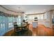 Eat-in kitchen with white cabinets, stainless appliances, and an adjacent dining area at 1703 Rifle Sw Rdg, Marietta, GA 30064