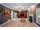 Cozy living room with a fireplace, elegant built-in shelving, and crown molding detailing at 1703 Rifle Sw Rdg, Marietta, GA 30064