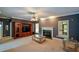 Open-concept living room featuring a fireplace and a built-in entertainment center at 1703 Rifle Sw Rdg, Marietta, GA 30064