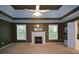 Relax in this spacious main bedroom with a tray ceiling, fireplace, and adjoining bathroom at 1703 Rifle Sw Rdg, Marietta, GA 30064