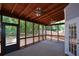 Enjoy the outdoors in this screened porch with ceiling fans and wooded views for relaxing and entertaining at 1703 Rifle Sw Rdg, Marietta, GA 30064