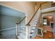 Traditional staircase with carpeted steps, wood railing, and white spindles leading to the upper level at 1703 Rifle Sw Rdg, Marietta, GA 30064