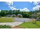 Street view of the house in a lovely neighborhood and featuring well-manicured lawns and mature trees at 1703 Rifle Sw Rdg, Marietta, GA 30064