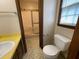 Bathroom featuring a toilet, shower with gold trim, and a patterned floor at 2104 Moon Sw Dr, Conyers, GA 30094