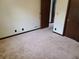 Bedroom featuring carpeting, closet, and dark trim at 2104 Moon Sw Dr, Conyers, GA 30094