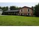 Charming two-story home featuring a brick facade and inviting front yard with mature landscaping at 2104 Moon Sw Dr, Conyers, GA 30094