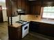 Well-equipped kitchen with classic cabinetry, gas range, and open layout at 2104 Moon Sw Dr, Conyers, GA 30094