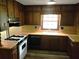 Efficient kitchen with dark cabinetry, gas range, and laminate countertops at 2104 Moon Sw Dr, Conyers, GA 30094