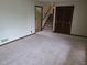 Spacious living room with carpet, view of stairs, and a closet, ideal for Gathering gatherings and relaxation at 2104 Moon Sw Dr, Conyers, GA 30094