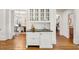 Convenient bar area with sink, storage, granite countertop, and glass-front cabinets at 235 The Prado N, Atlanta, GA 30309