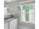 Charming bathroom with white vanity, marble countertop, and a bright window at 235 The Prado N, Atlanta, GA 30309