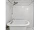 Bathroom featuring soaking tub, a rainfall shower head, and white subway tile at 235 The Prado N, Atlanta, GA 30309