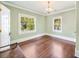 Light green bedroom with original hardwood floors, baseboard trim, and a chandelier light fixture at 235 The Prado N, Atlanta, GA 30309