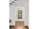 Elegant foyer with hardwood floors, arched doorway, and staircase, creating a welcoming entrance at 235 The Prado N, Atlanta, GA 30309