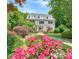 Charming two-story home with a manicured front yard and beautiful flower beds at 235 The Prado N, Atlanta, GA 30309