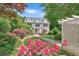 Well-maintained front yard with a white home in the background and a pergola on the right at 235 The Prado N, Atlanta, GA 30309