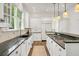 White kitchen featuring granite counters, stainless appliances, and eat-in island at 235 The Prado N, Atlanta, GA 30309