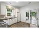 Bright kitchen features black countertops, white cabinets and opens to a screened in back porch at 235 The Prado N, Atlanta, GA 30309