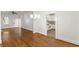 Open floor plan with hardwood floors flows to a kitchen with white cabinets and appliances at 235 The Prado N, Atlanta, GA 30309