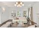 Bright living room featuring a fireplace, hardwood floors, built-ins, and neutral decor at 235 The Prado N, Atlanta, GA 30309