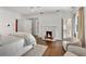 Bright main bedroom featuring hardwood floors, fireplace, seating area, and ensuite bathroom at 235 The Prado N, Atlanta, GA 30309