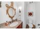 Elegant powder room with granite counter, wood vanity, ornate mirror, and decorative touches at 235 The Prado N, Atlanta, GA 30309
