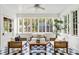 Bright sunroom with checkered tile floor, lots of windows and wicker furniture at 235 The Prado N, Atlanta, GA 30309