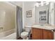 Bathroom featuring a shower-tub combo with patterned curtain, toilet, and vanity at 3901 Old Atlanta Station Se Dr, Atlanta, GA 30339