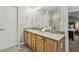 Bathroom featuring double sinks with wood cabinetry and a glass-enclosed shower at 3901 Old Atlanta Station Se Dr, Atlanta, GA 30339