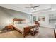 Bedroom with a tray ceiling, gray accent wall, and a wooden sleigh bed with bedside tables at 3901 Old Atlanta Station Se Dr, Atlanta, GA 30339
