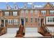 Beautiful townhome featuring a brick facade, attached garage, and manicured front yard at 3901 Old Atlanta Station Se Dr, Atlanta, GA 30339