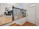 Welcoming foyer with wood floors, chandelier, black iron staircase, and front door with transom window at 3901 Old Atlanta Station Se Dr, Atlanta, GA 30339