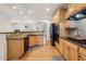 Kitchen area with wood cabinets, stone countertops, stainless steel appliances, and hardwood flooring at 3901 Old Atlanta Station Se Dr, Atlanta, GA 30339
