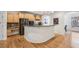 Open kitchen featuring a breakfast bar, wood cabinets, stainless steel appliances, and hardwood floors at 3901 Old Atlanta Station Se Dr, Atlanta, GA 30339