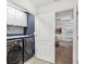 Modern laundry room with a front load washer and dryer and white cabinets at 3901 Old Atlanta Station Se Dr, Atlanta, GA 30339