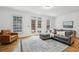 Bright living room showcasing a comfortable sofa, leather chair, and elegant area rug at 3901 Old Atlanta Station Se Dr, Atlanta, GA 30339