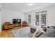 Comfortable living room with a large sofa, accent chairs, hardwood floors, and outdoor access at 3901 Old Atlanta Station Se Dr, Atlanta, GA 30339